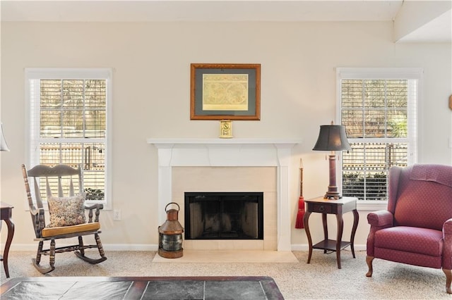 sitting room with a fireplace and carpet floors