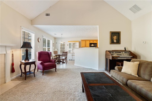 living room with high vaulted ceiling and light carpet