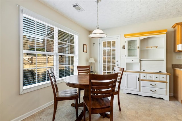 dining area featuring a textured ceiling