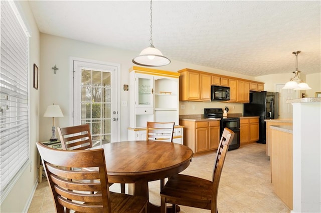 dining space with light tile patterned floors and a textured ceiling