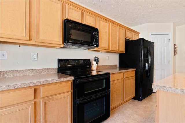 kitchen with light brown cabinetry, light tile patterned floors, a textured ceiling, and black appliances