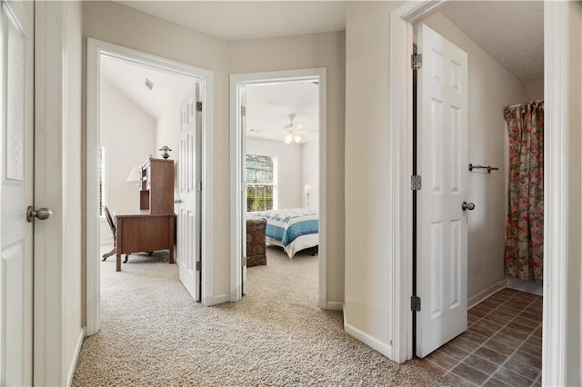 hallway with carpet floors