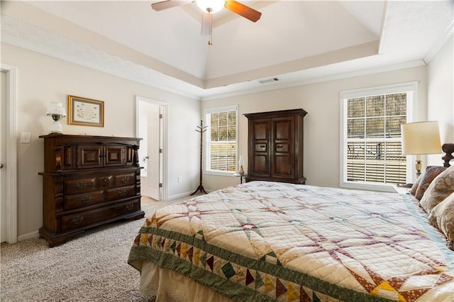 carpeted bedroom featuring crown molding, a raised ceiling, and ceiling fan