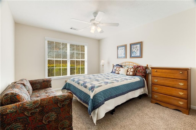 bedroom with ceiling fan and light carpet