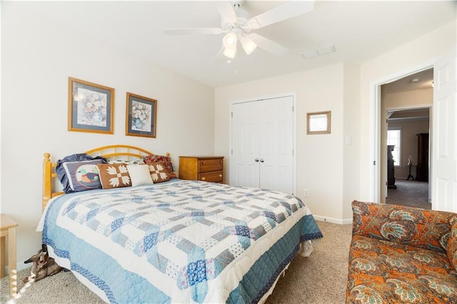 carpeted bedroom with ceiling fan and a closet