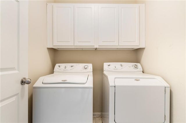 laundry area featuring cabinets and washing machine and dryer