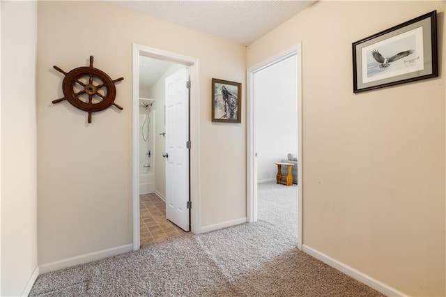 hallway featuring light colored carpet