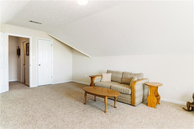 sitting room with vaulted ceiling and light carpet