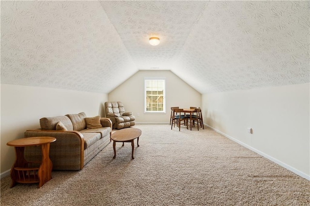 interior space featuring lofted ceiling, carpet floors, and a textured ceiling