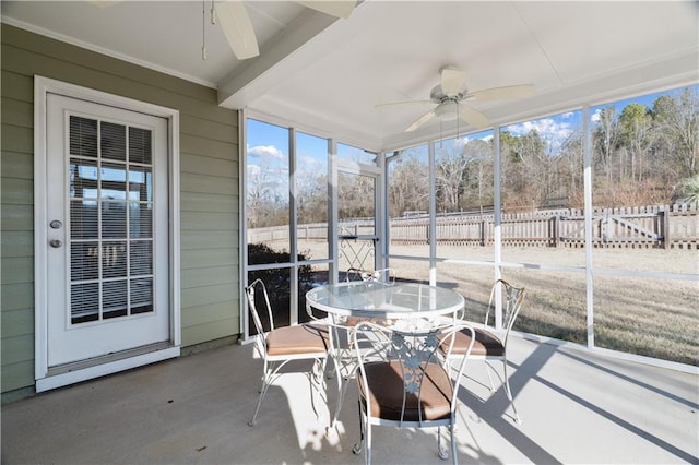 sunroom / solarium with beamed ceiling and ceiling fan