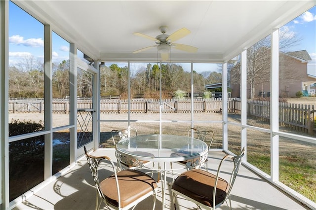 sunroom / solarium with plenty of natural light and ceiling fan