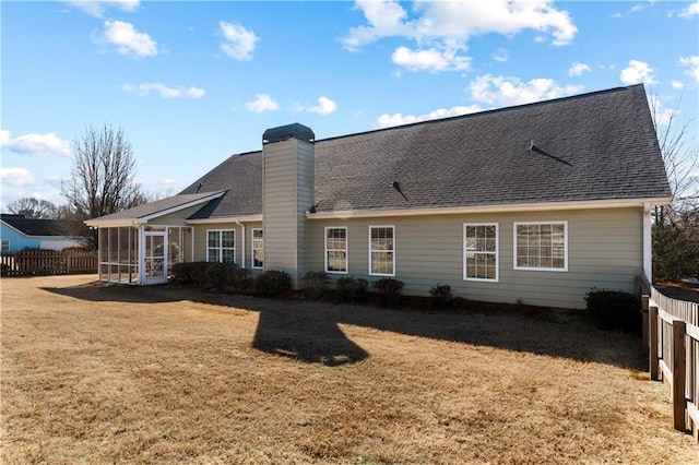 back of property featuring a yard and a sunroom