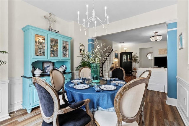 dining room featuring wood finished floors and a notable chandelier