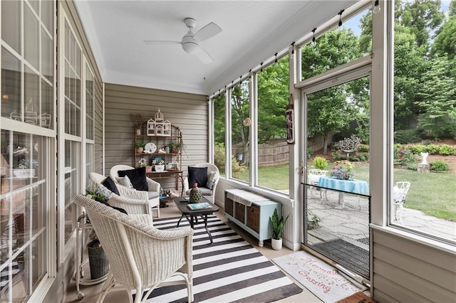 sunroom / solarium with a ceiling fan