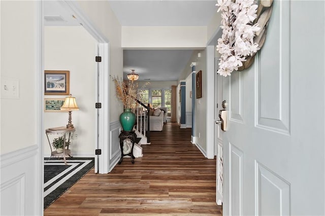 entryway featuring visible vents, baseboards, and wood finished floors