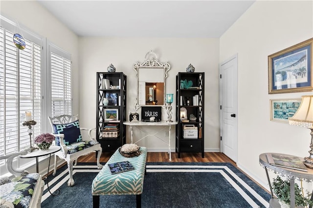 living area featuring baseboards and wood finished floors