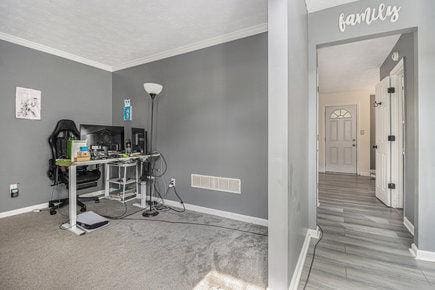 office space with ornamental molding and hardwood / wood-style flooring