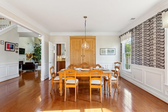 dining area featuring crown molding and wood-type flooring