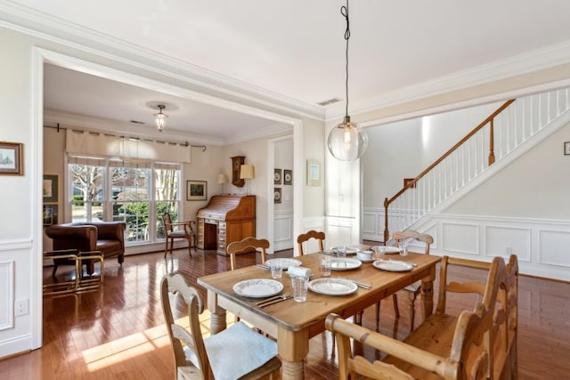 dining room featuring ornamental molding and dark hardwood / wood-style flooring