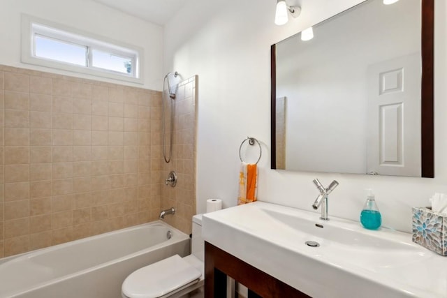 full bathroom with tiled shower / bath, vanity, and toilet