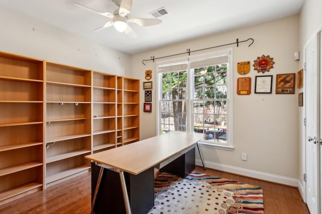 office with wood-type flooring and ceiling fan