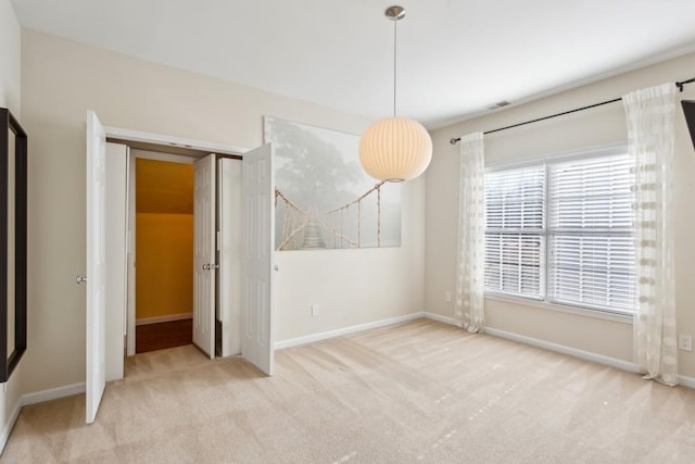 empty room featuring light colored carpet