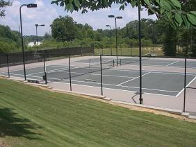 view of sport court featuring a lawn