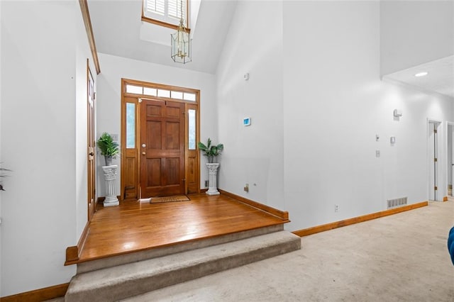 1732 Winding Woods Ln, Jonesboro, GA 30236 - carpeted foyer with high vaulted ceiling, healthy amount of natural light, and a chandelier
