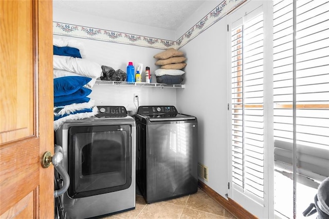 1732 Winding Woods Ln, Jonesboro, GA 30236 - washroom featuring washing machine and clothes dryer, light tile patterned floors, and a textured ceiling