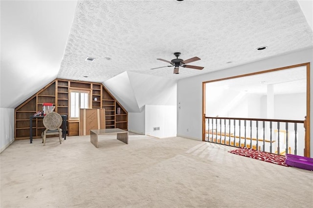 1732 Winding Woods Ln, Jonesboro, GA 30236 - bonus room with a ceiling fan, built in shelves, vaulted ceiling, carpet floors, and a textured ceiling