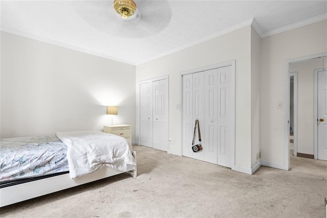 1732 Winding Woods Ln, Jonesboro, GA 30236 - carpeted bedroom with ornamental molding, multiple closets, and a ceiling fan