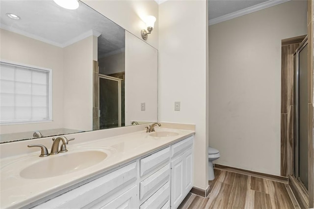 1732 Winding Woods Ln, Jonesboro, GA 30236 - bathroom featuring a shower stall, double vanity, ornamental molding, and wood finished floors