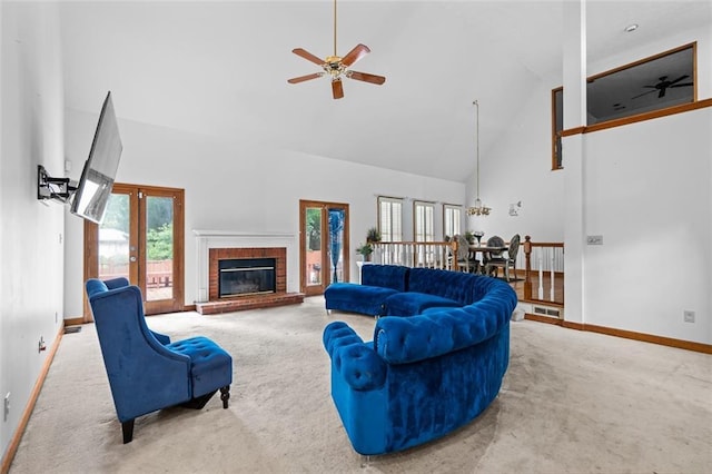 1732 Winding Woods Ln, Jonesboro, GA 30236 - carpeted living room featuring high vaulted ceiling, ceiling fan, plenty of natural light, a brick fireplace, and french doors