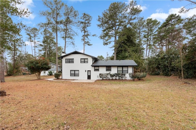 rear view of property with a yard