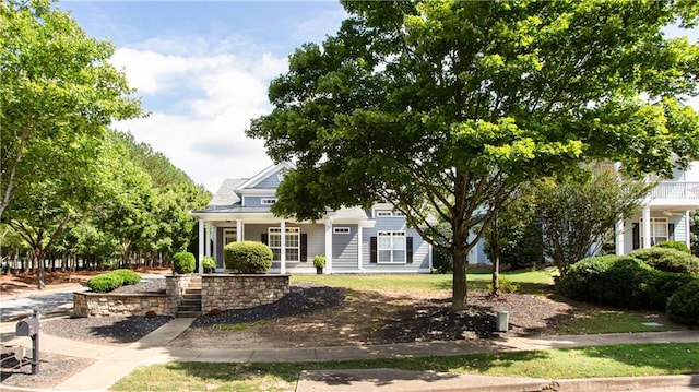 view of property hidden behind natural elements with a porch