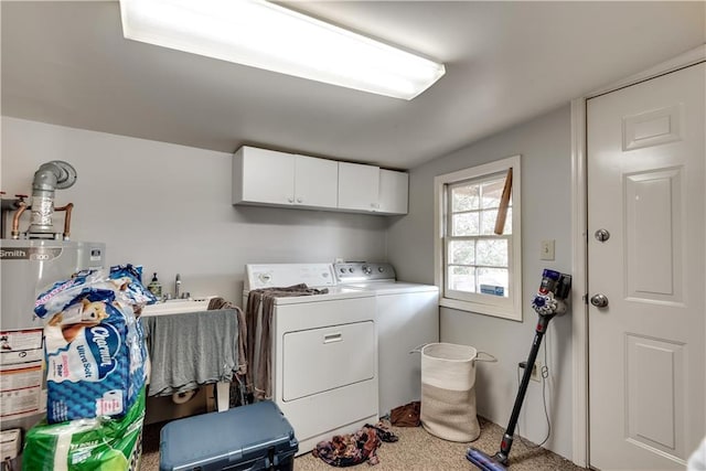 clothes washing area featuring separate washer and dryer, water heater, cabinets, and carpet flooring