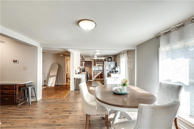 dining space featuring wood-type flooring