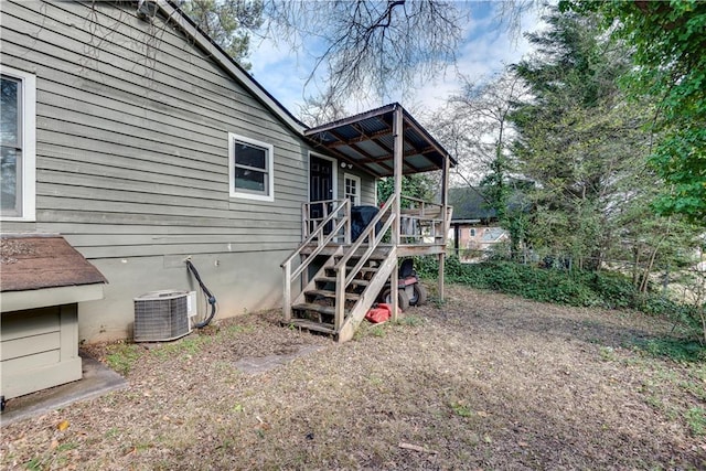 view of side of home featuring central AC unit