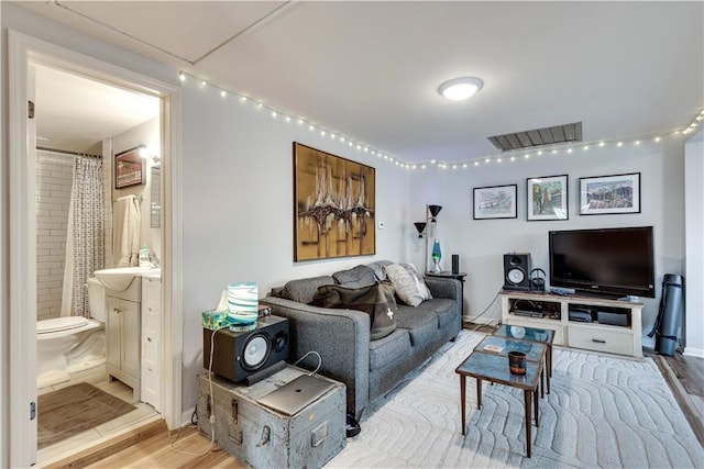 living room with sink and hardwood / wood-style floors