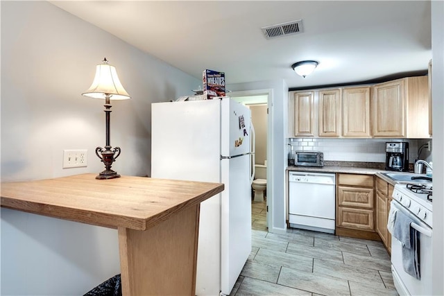 kitchen with sink, white appliances, backsplash, light brown cabinetry, and kitchen peninsula