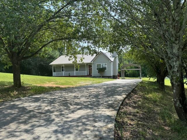 263 SW Hardin Rd SW, Plainville, GA 30733 - ranch-style home featuring a porch, a chimney, driveway, and a front yard