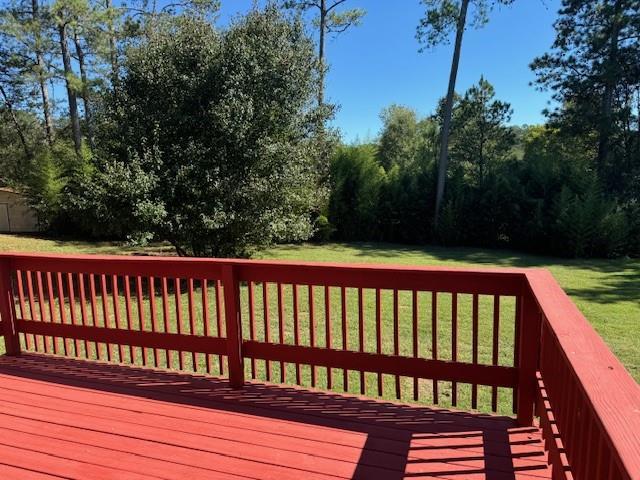 wooden deck with a lawn
