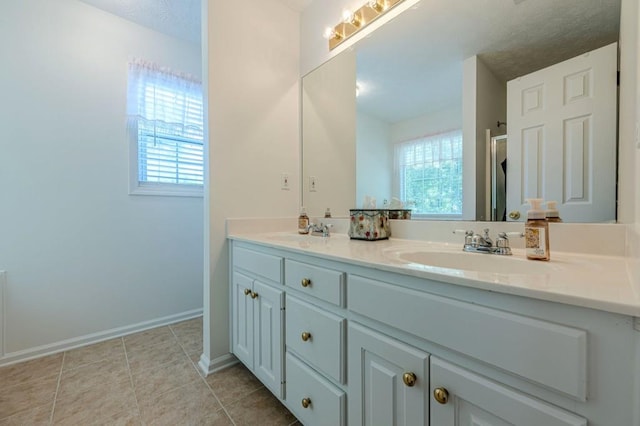 435 Flowering Trl, Grayson, GA 30017 - full bath with double vanity, plenty of natural light, baseboards, and tile patterned floors