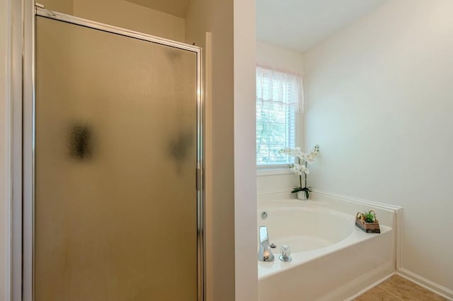 435 Flowering Trl, Grayson, GA 30017 - full bathroom with a shower stall, a garden tub, and baseboards