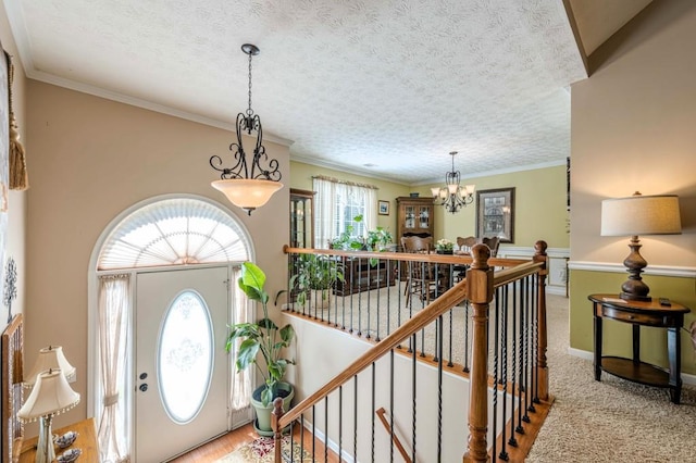 435 Flowering Trl, Grayson, GA 30017 - entrance foyer with a chandelier, a textured ceiling, baseboards, and crown molding