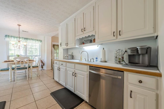435 Flowering Trl, Grayson, GA 30017 - kitchen featuring stainless steel dishwasher, a sink, a textured ceiling, light countertops, and white cabinetry