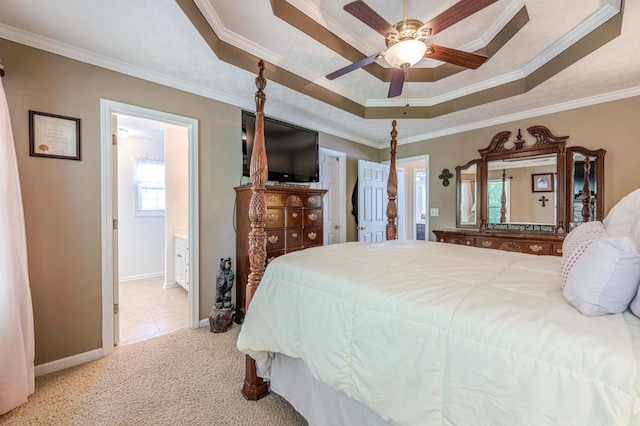 435 Flowering Trl, Grayson, GA 30017 - carpeted bedroom featuring a raised ceiling, ornamental molding, ensuite bath, baseboards, and a ceiling fan
