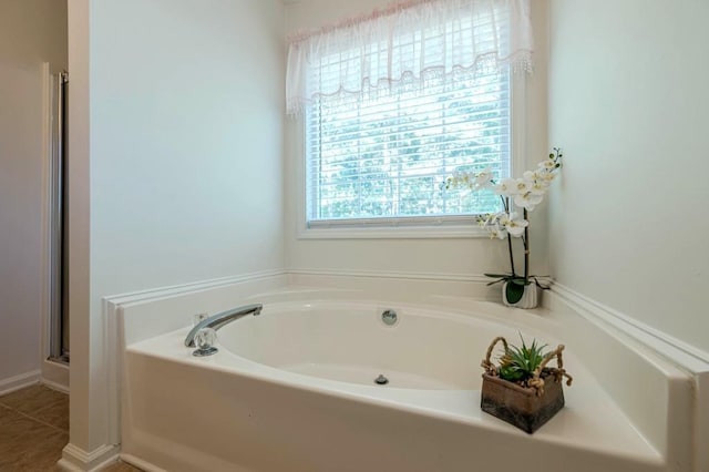 435 Flowering Trl, Grayson, GA 30017 - bathroom with a garden tub and a shower with door