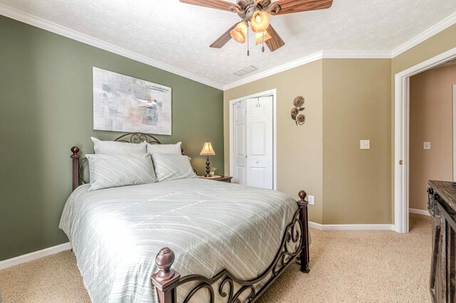 435 Flowering Trl, Grayson, GA 30017 - bedroom with light carpet, a closet, baseboards, ceiling fan, and a textured ceiling