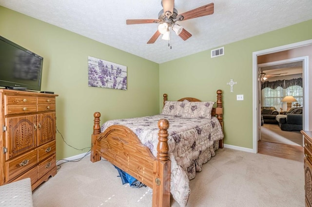 435 Flowering Trl, Grayson, GA 30017 - bedroom featuring light colored carpet, a textured ceiling, ceiling fan, and baseboards